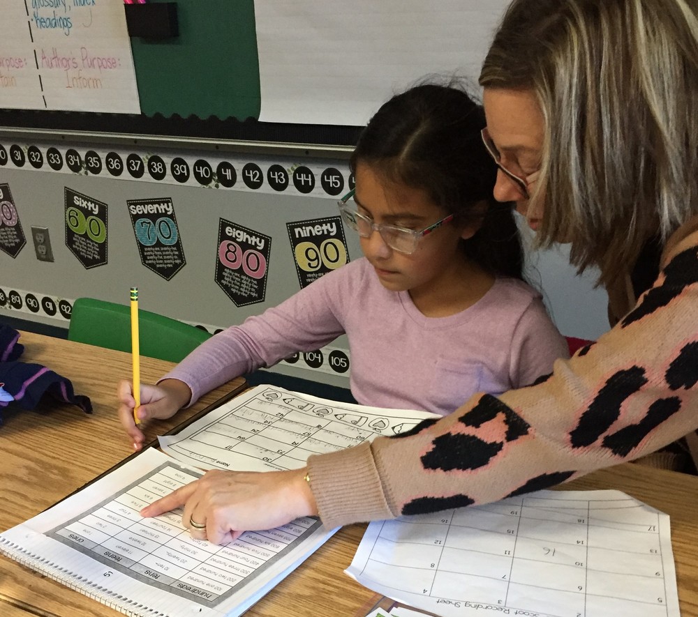 Teacher helping student