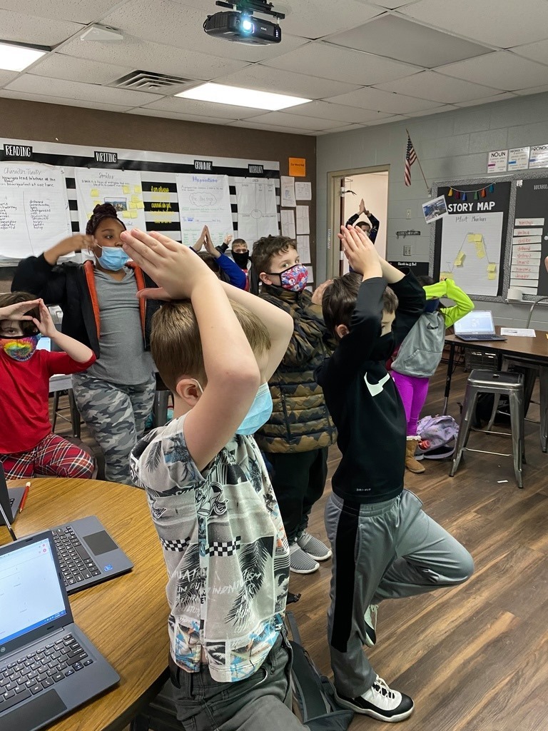These students practice memorizing their figurative language skill as they hold a yoga pose while saying it. 