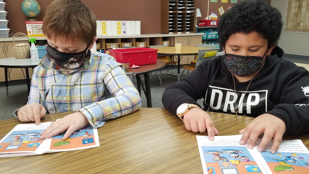 A first grade reading group is reading "Doing the Right Thing" and discussing what they should do in different scenarios. #CPSZEBRAPRIDE
