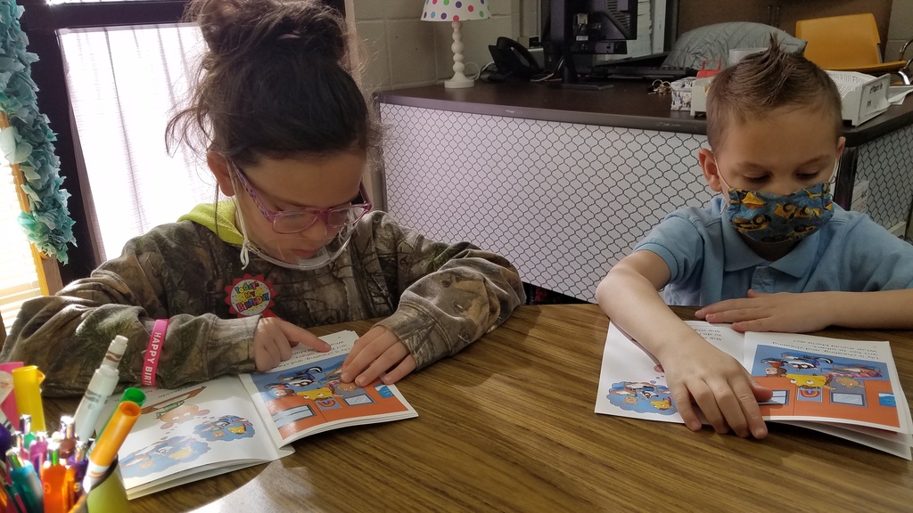 A first grade reading group is reading "Doing the Right Thing" and discussing what they should do in different scenarios. #CPSZEBRAPRIDE