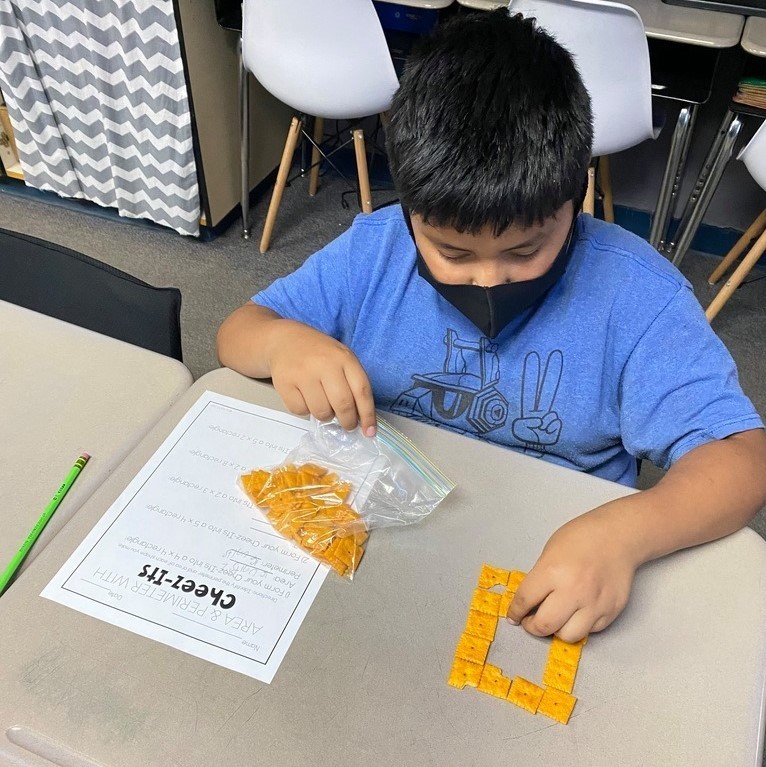 Mrs. Castle's 3rd grade WIN group practices area and perimeter with Cheezits. 