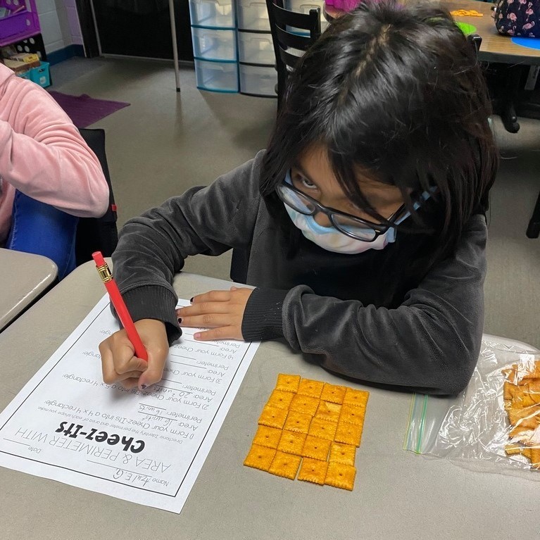 Mrs. Castle's 3rd grade WIN group practices area and perimeter with Cheezits.