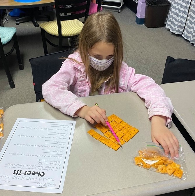 Mrs. Castle's 3rd grade WIN group practices area and perimeter with Cheezits. 