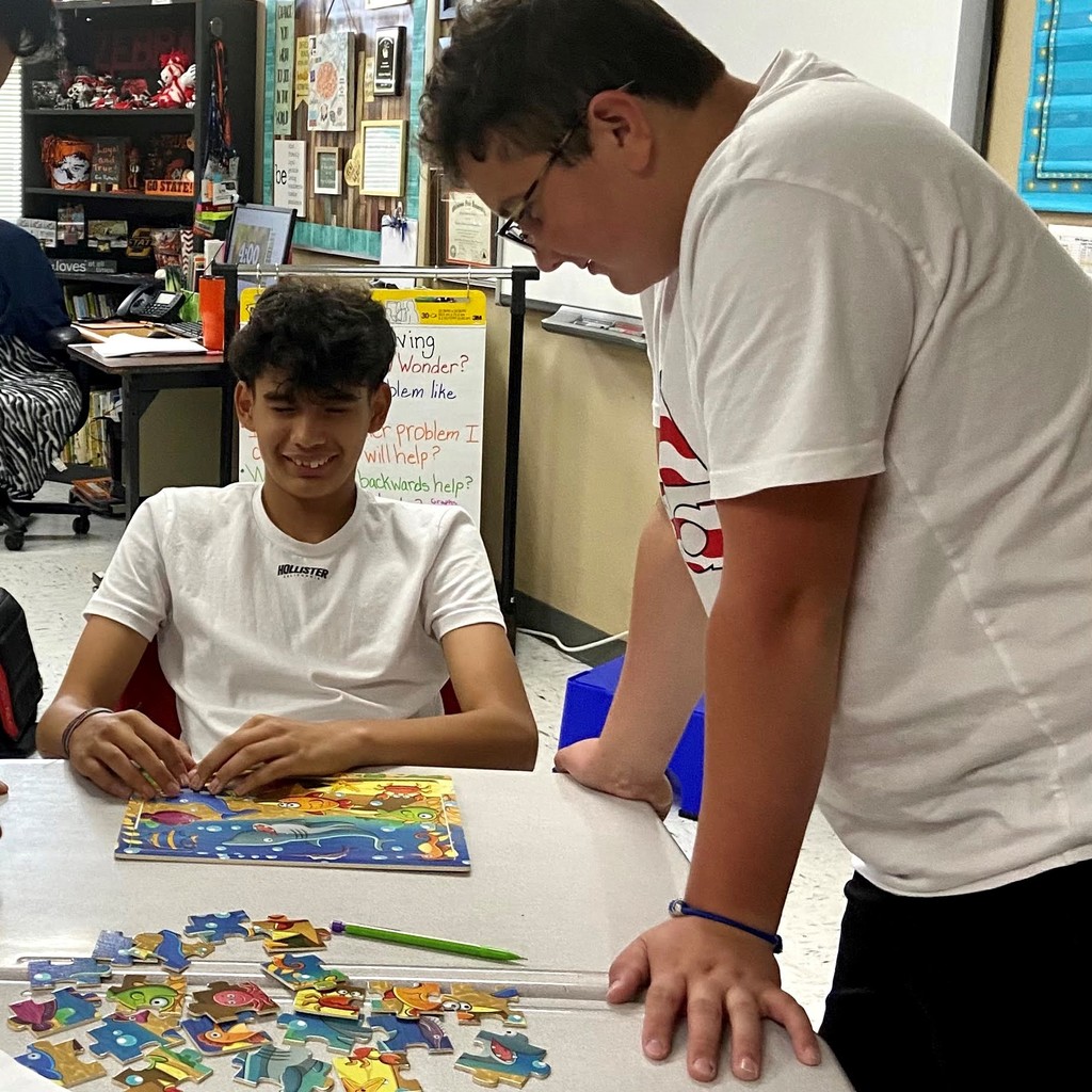 boys putting together puzzle