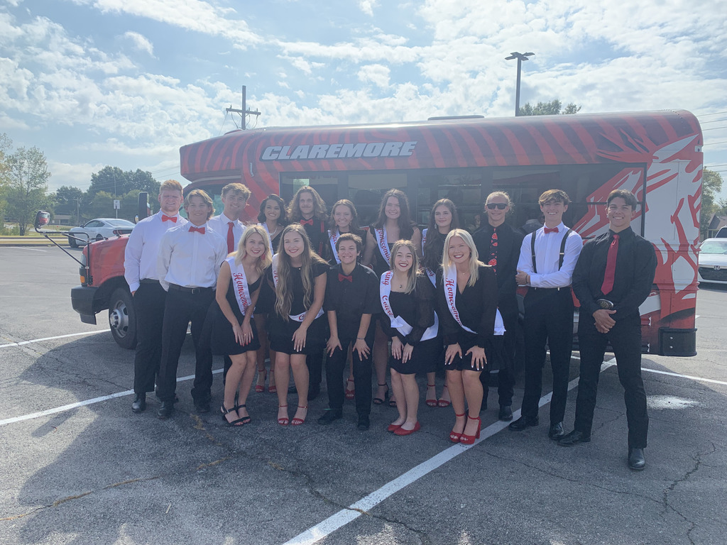 homecoming court in front of zebra logo bus