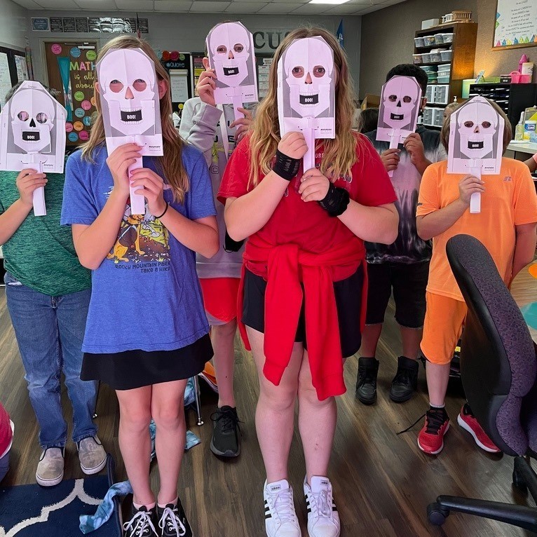 students with masks of their cranium 