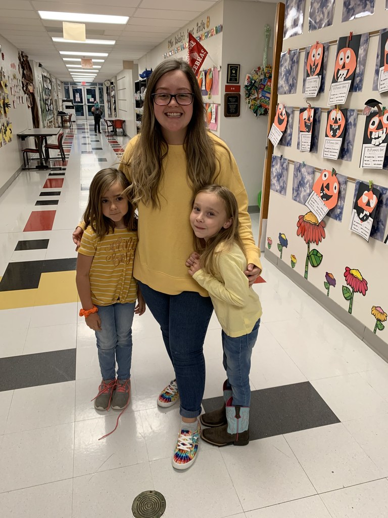 TEACHER AND TWO GIRLS IN YELLOW