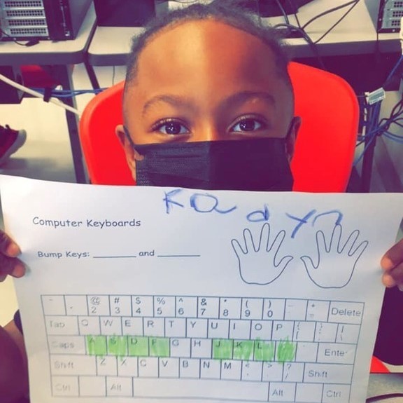 student with paper keyboard