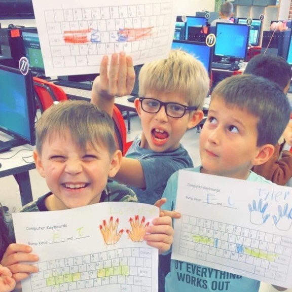 students with paper keyboard
