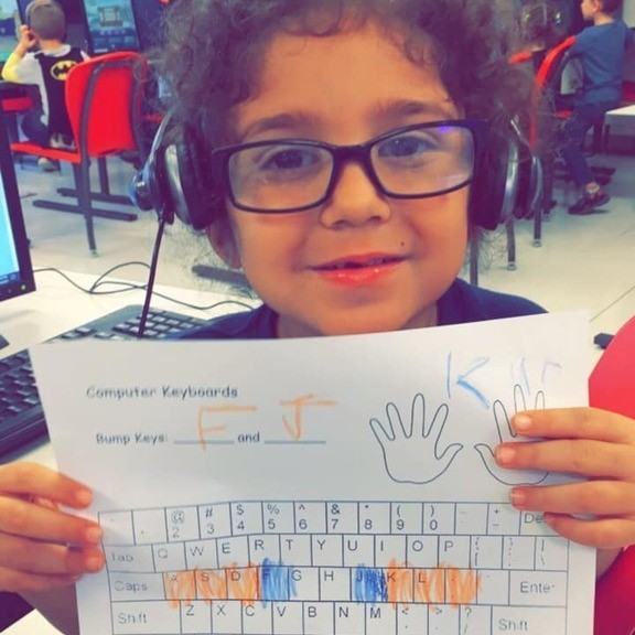 student with paper keyboard