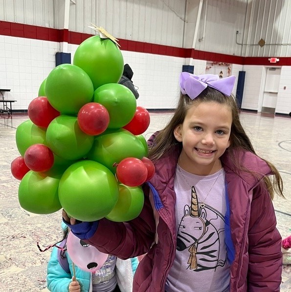students with Christmas tree balloon characters