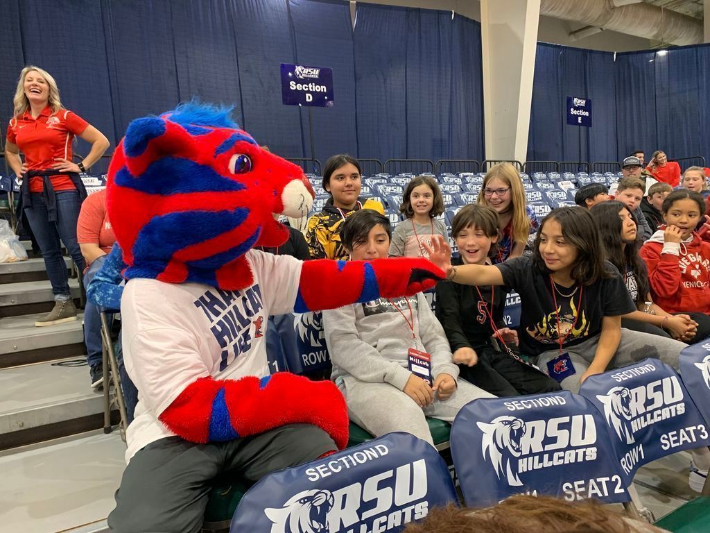 RSU Hillcat mascot giving student nucks