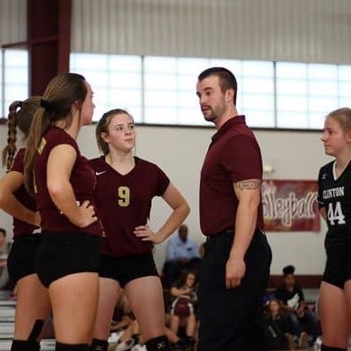 Coach Jackson talking to 3 players