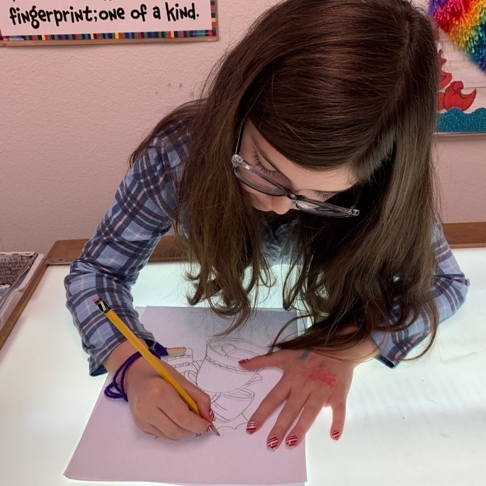 student tracing on the lightboard