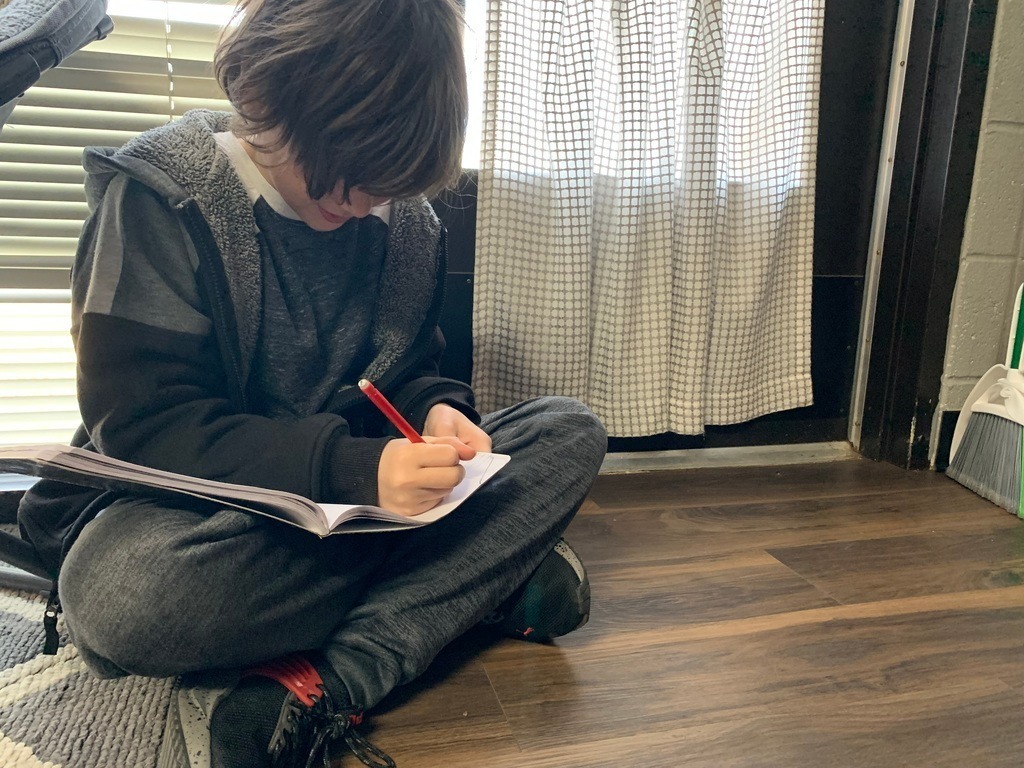 student writing in a journal 