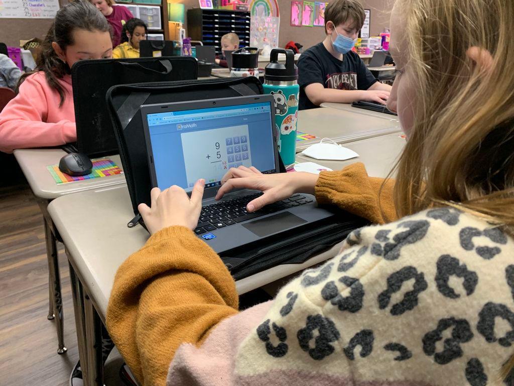 student work on math on laptop 