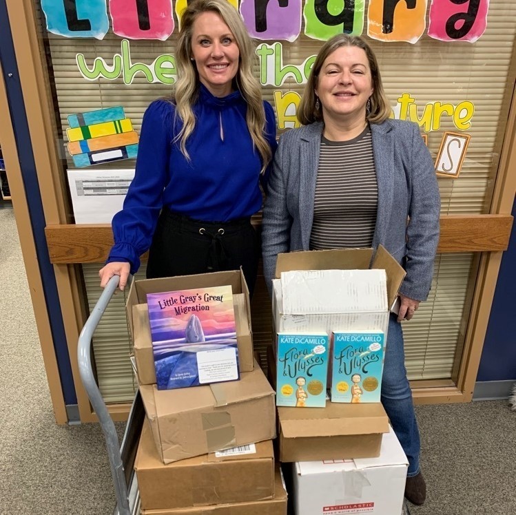 principal and council director with boxes of books