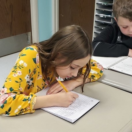 student writing in journal 