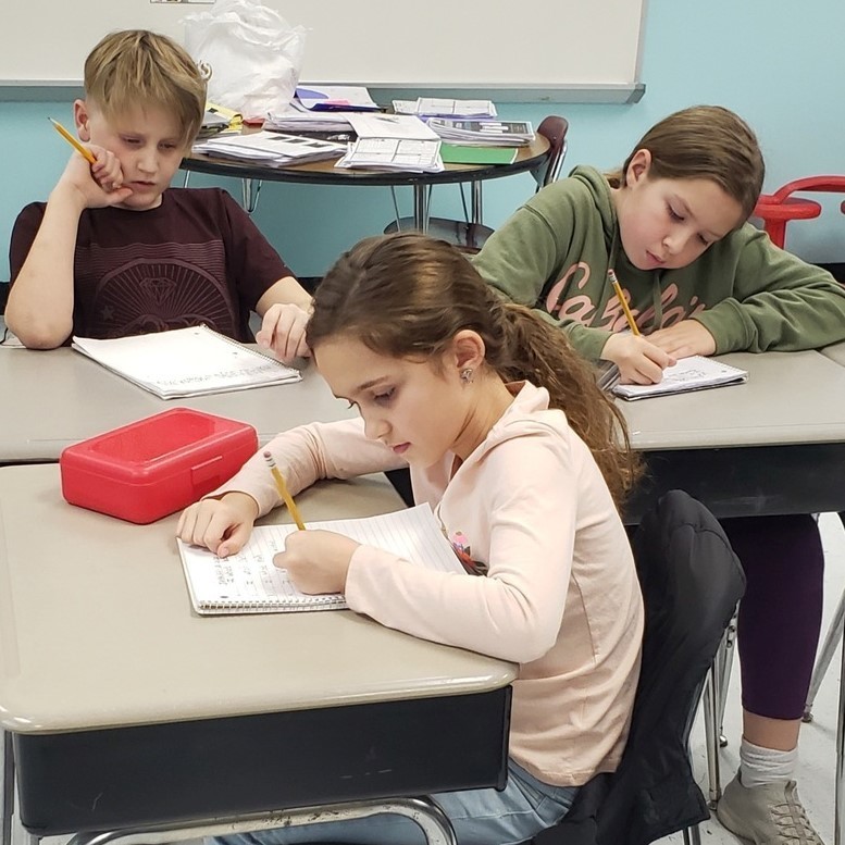 student writing in journal