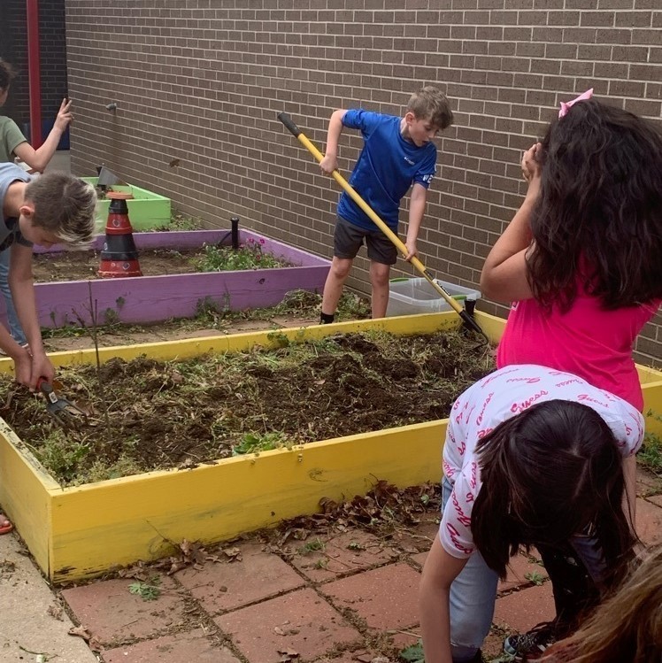 kids cleaning raised beds