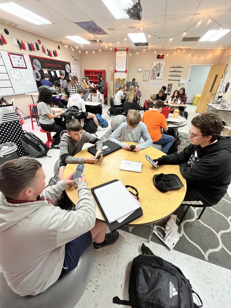 students around a table with calculators