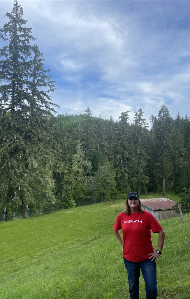 person standing in front of evergreen trees