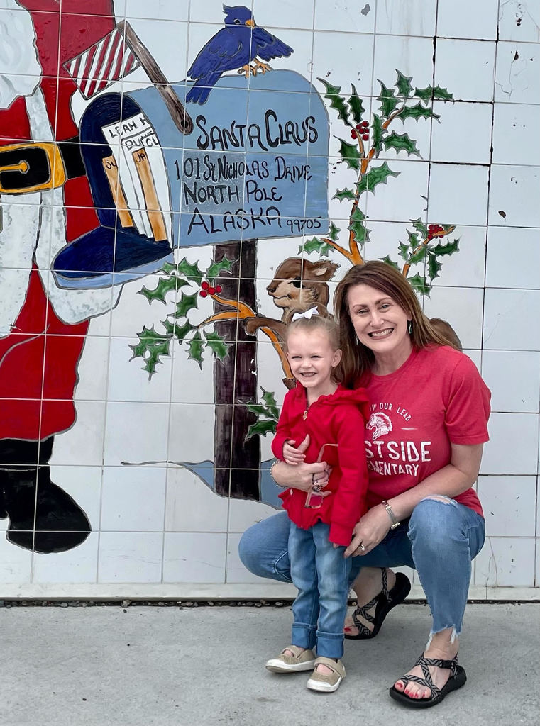 Mrs. T & granddaughter in front of North Pole mural.