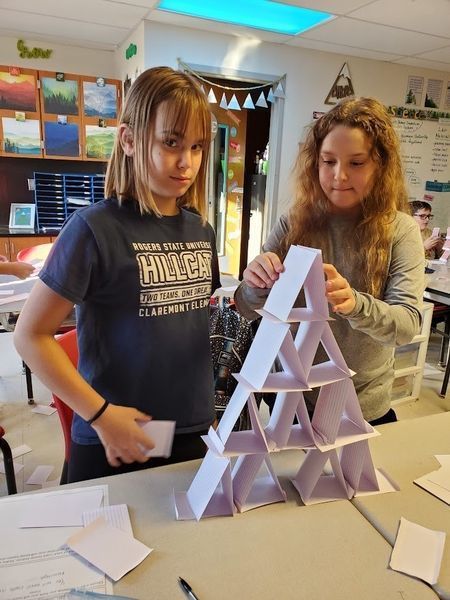 students building a towers out of index cards