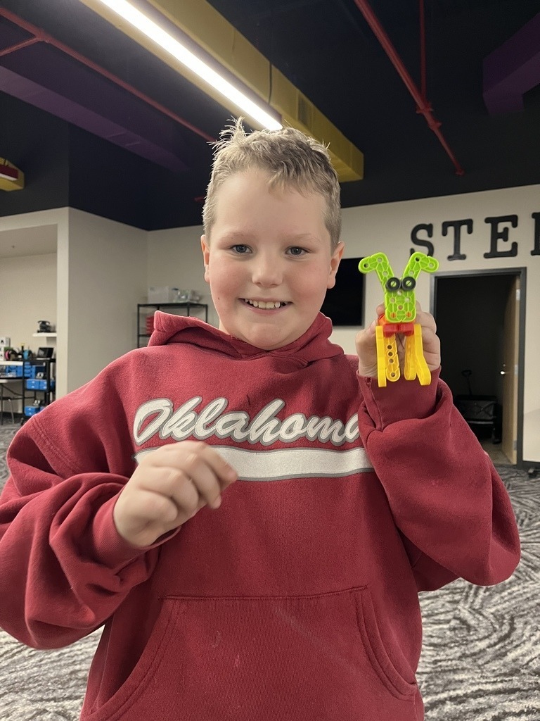 student holding 3D creation