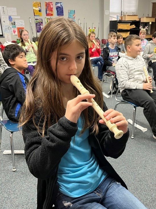 student playing the recorder