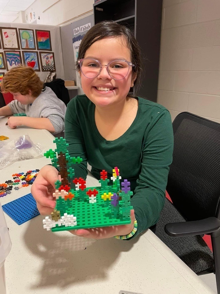 student smiling with manipulatives