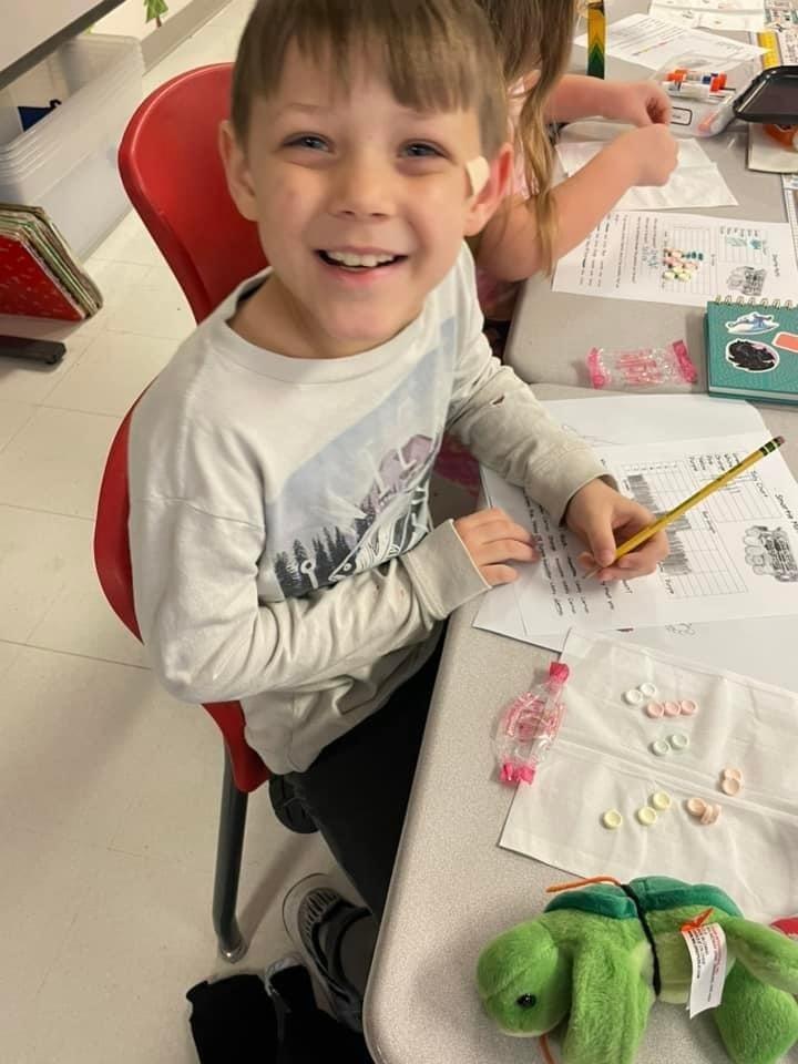 student with graphing worksheet using sweetarts