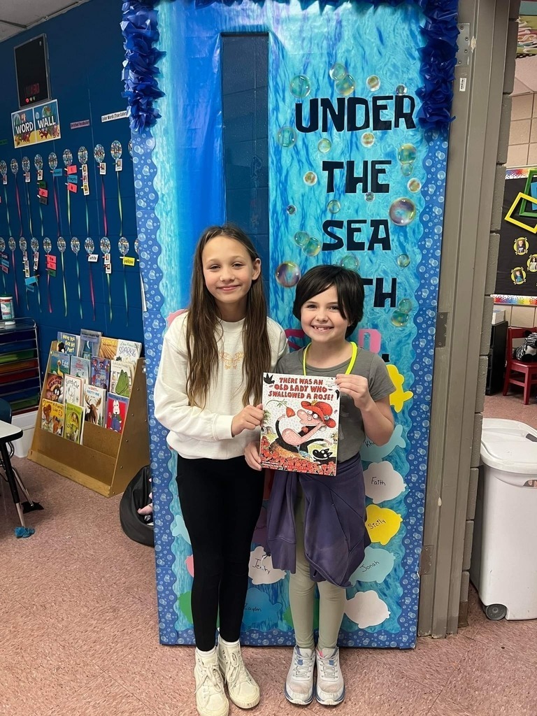 third graders with a book