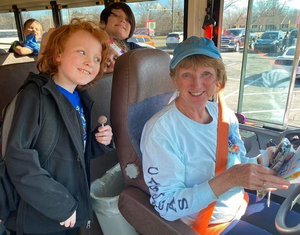 students with bus driver