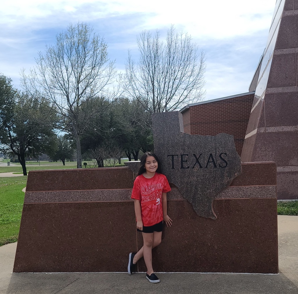 girl standing in front of texas sign