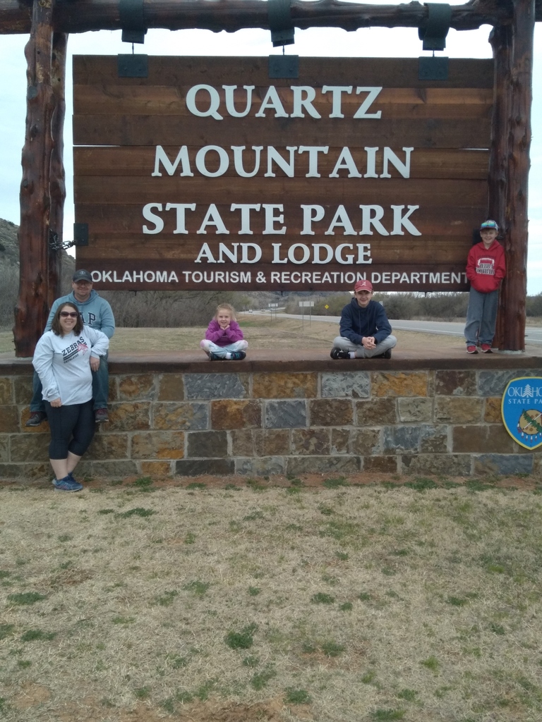 family by state park sign 