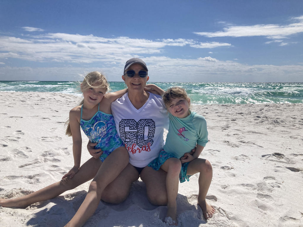 girls with grandma on beach