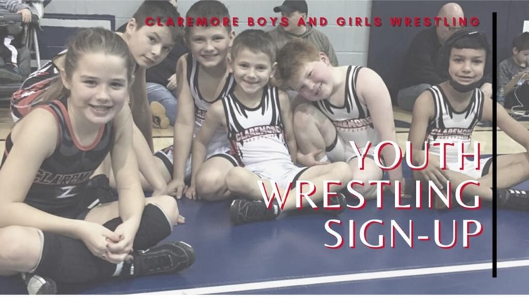 youth in wrestling singlets on a mat