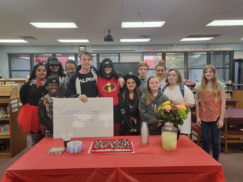 lakey and students with congratulations sign